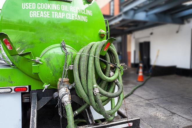 grease trap pumping truck in action in Milford